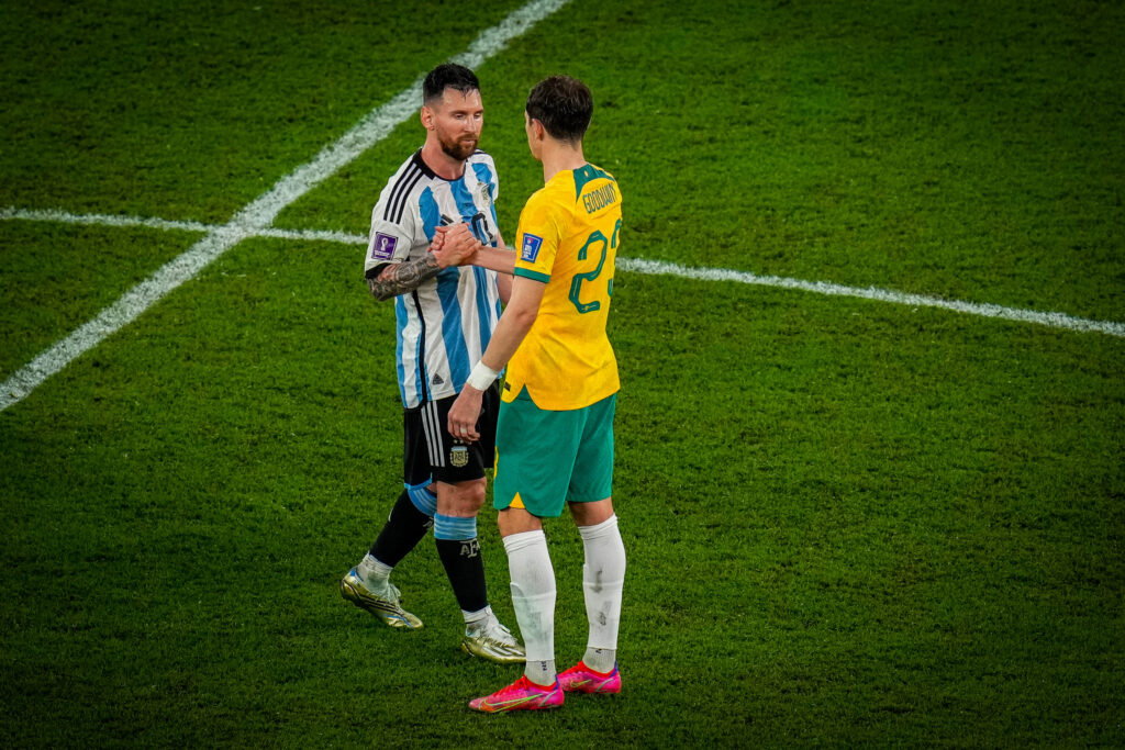 Argentina's Lionel Messi, left, is greeted by Australia's Craig Goodwin at the end of the World Cup round of 16 soccer match between Argentina and Australia at the Ahmad Bin Ali Stadium in Doha, Qatar,