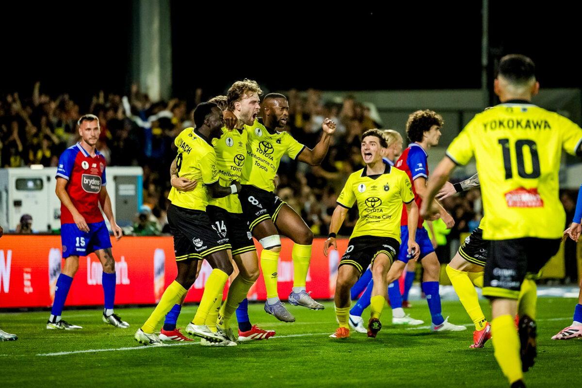 Heidelberg United players celebrating after a goal during their Australia Cup run, showcasing Victorian football disruption